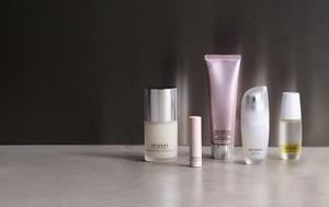 Winter skincare essentials next to each other on grey table top with mood lighting 